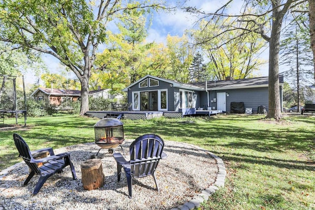 view of yard with a fire pit and a deck