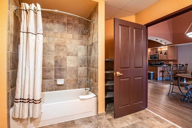 bathroom with wood-type flooring and shower / bath combo