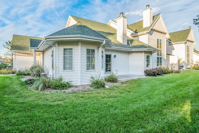 back of house featuring a patio, a yard, and central air condition unit