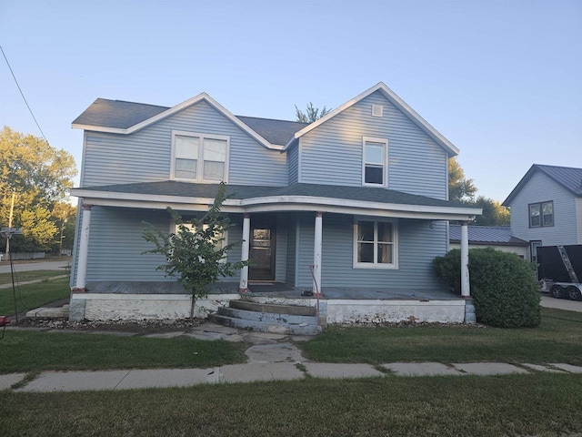 view of front of house with a porch and a front lawn