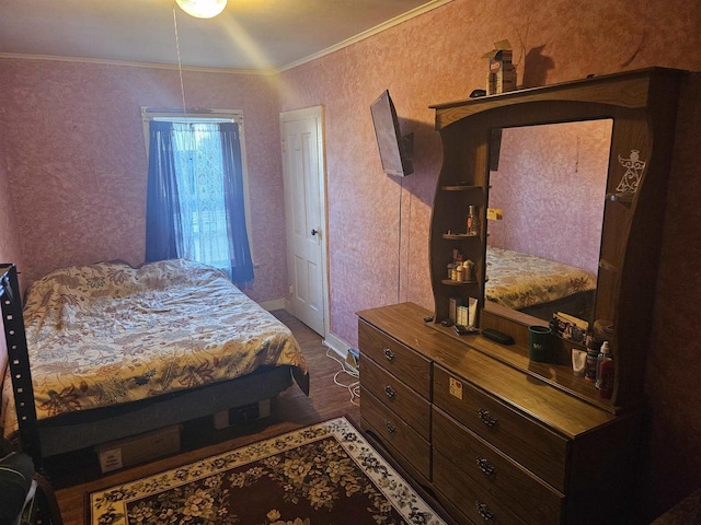 bedroom with dark hardwood / wood-style floors and crown molding