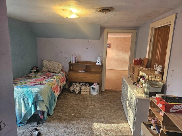 bedroom featuring carpet floors and a textured ceiling