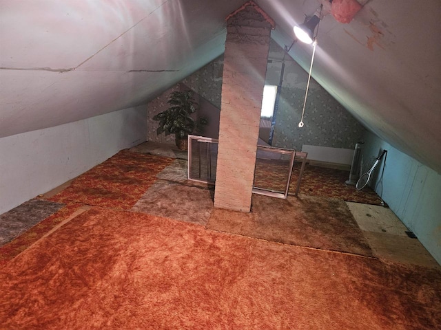 bonus room with lofted ceiling and carpet flooring