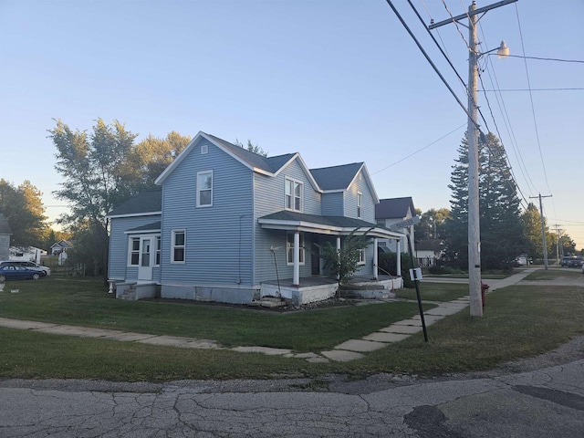 view of front of home featuring a lawn and a porch