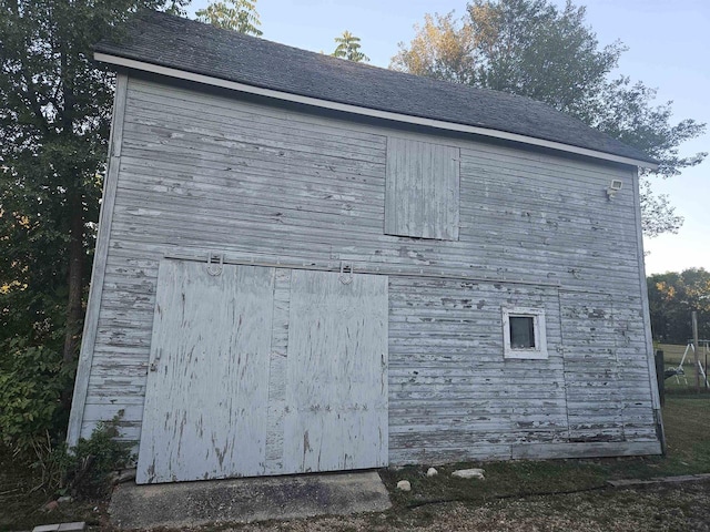 view of side of home featuring a shed