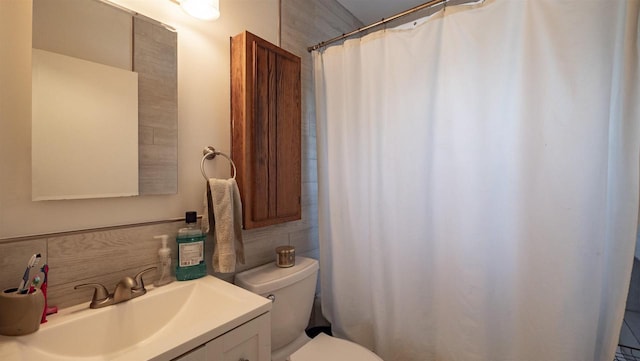 bathroom with walk in shower, vanity, and toilet