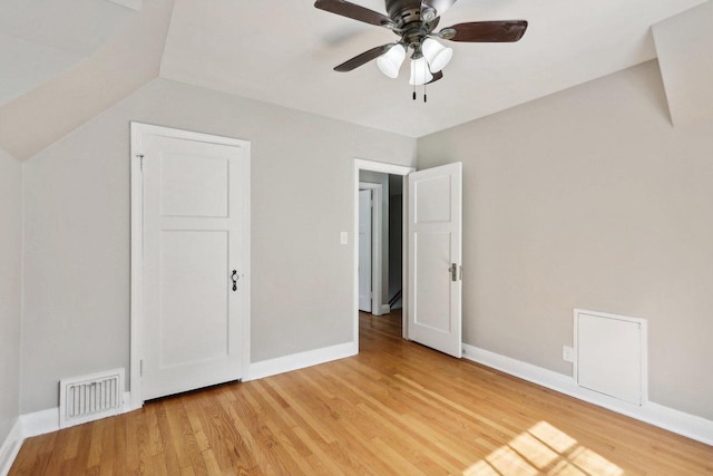 unfurnished bedroom with wood-type flooring, lofted ceiling, and ceiling fan