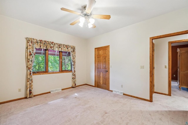 spare room with carpet and ceiling fan