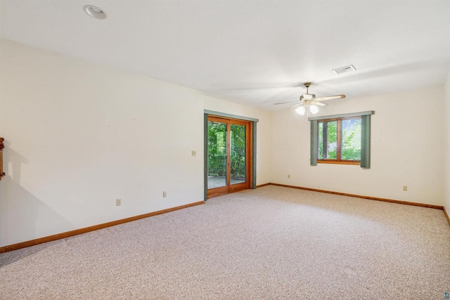 empty room with ceiling fan and carpet floors