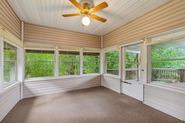 unfurnished sunroom with wooden ceiling and ceiling fan