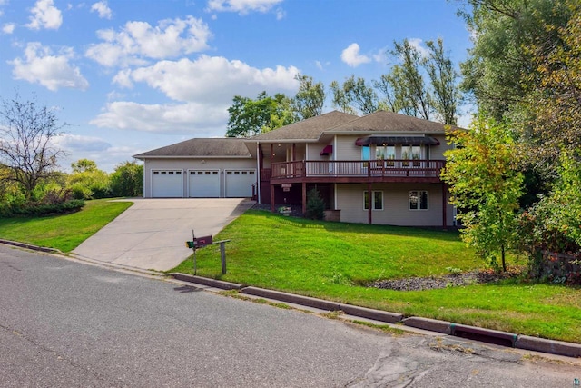 view of front of home featuring a garage, a deck, and a front lawn