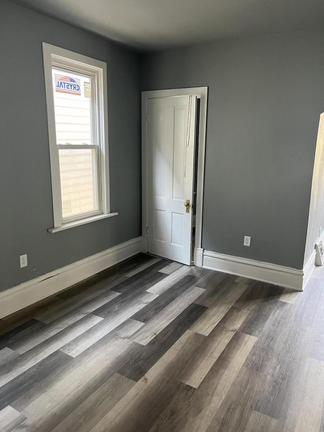 unfurnished bedroom featuring dark wood-type flooring