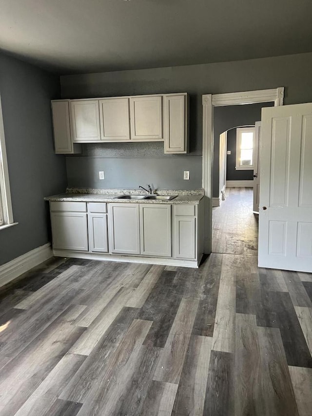 kitchen featuring white cabinets, hardwood / wood-style flooring, and sink