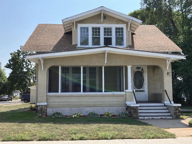 view of front of house with a front lawn and a porch