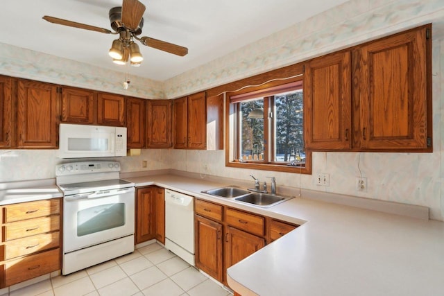 kitchen with sink, white appliances, light tile patterned floors, and ceiling fan