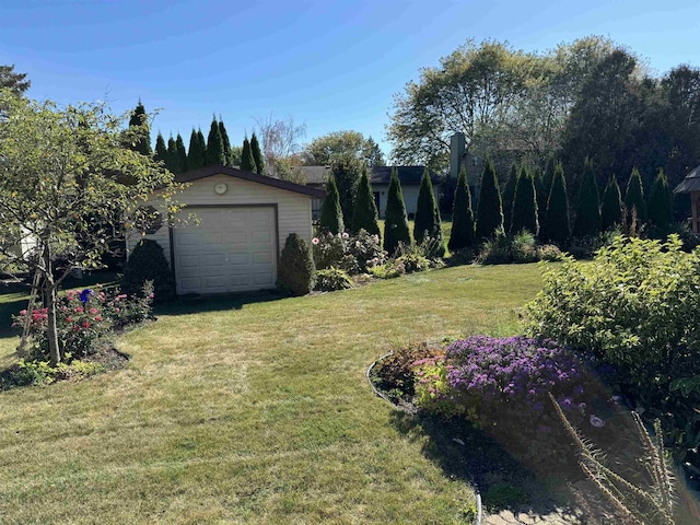 view of yard with a garage and an outdoor structure