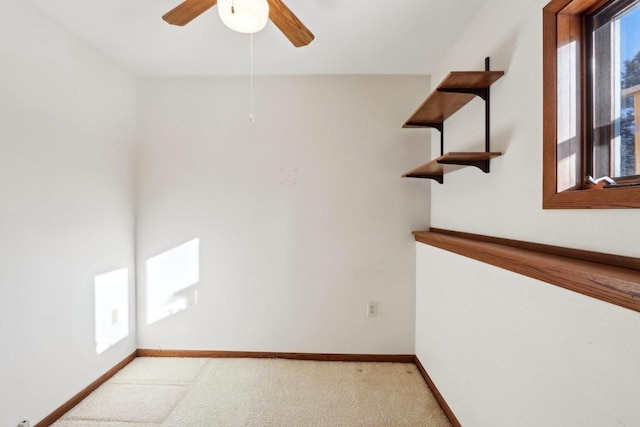 carpeted spare room with ceiling fan