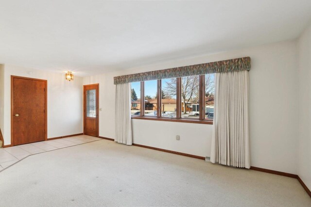 unfurnished room with light colored carpet