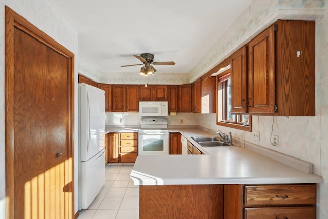 kitchen with light tile patterned flooring, sink, ceiling fan, kitchen peninsula, and white appliances