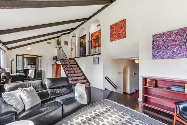 5302 Arapahoe Ln, Madison, WI 53704 - living room featuring stairs, arched walkways, lofted ceiling with beams, and hardwood / wood-style floors