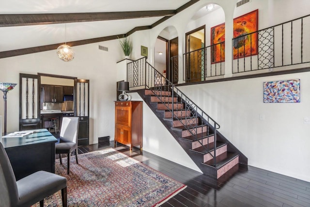 5302 Arapahoe Ln, Madison, WI 53704 - staircase featuring wood finished floors, beam ceiling, visible vents, and high vaulted ceiling