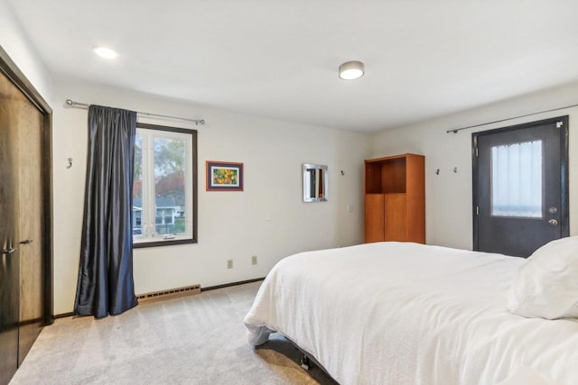 bedroom featuring a closet and light colored carpet