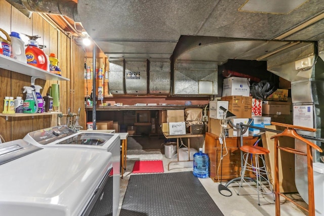 interior space featuring washer and dryer and wooden walls