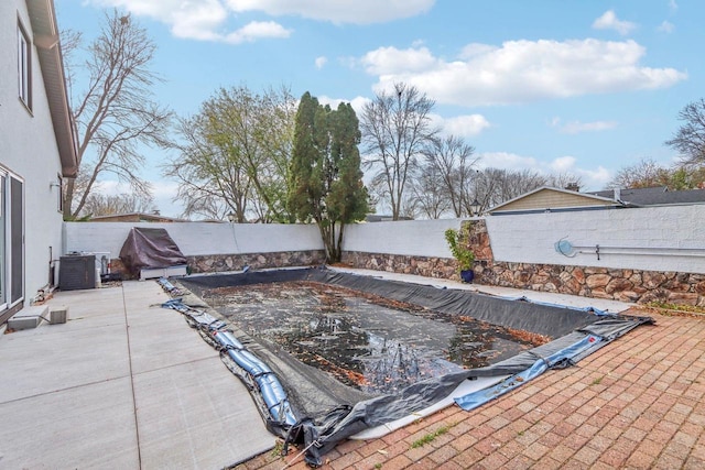 view of swimming pool featuring a patio and central AC unit