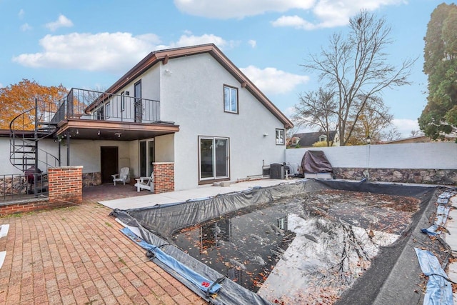 back of house featuring a patio and a balcony