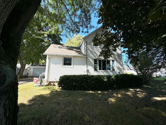 view of home's exterior with a yard and a garage