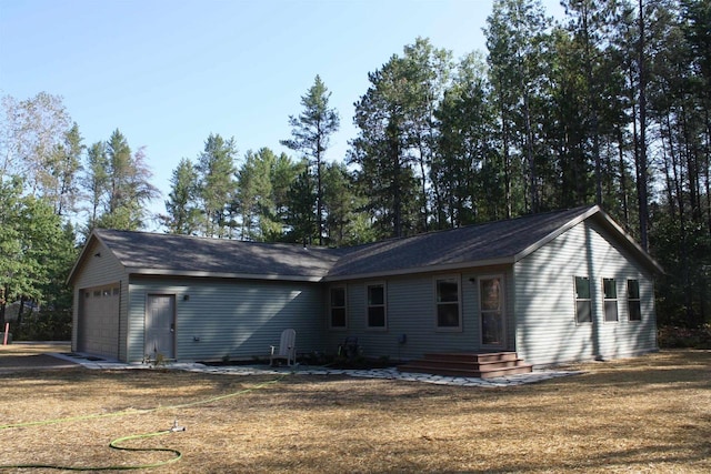 view of front of home featuring a garage and a front lawn