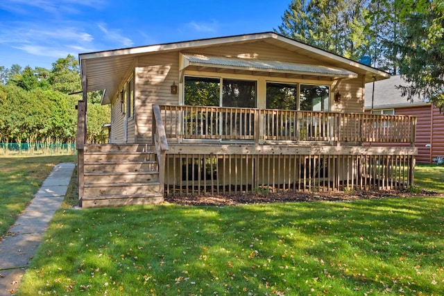 back of house with a wooden deck and a yard