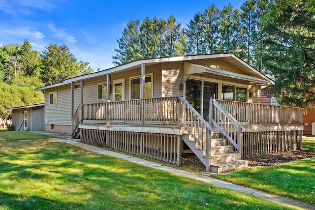 view of front of property with a wooden deck and a front lawn