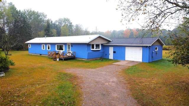 single story home with a front yard and a garage