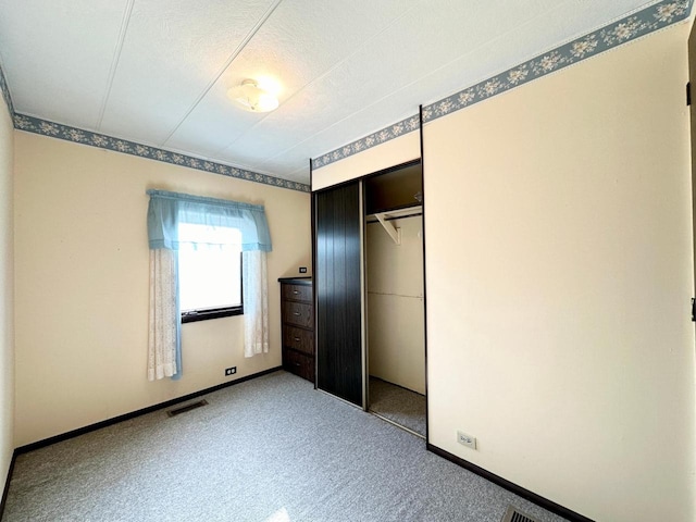 unfurnished bedroom with a closet and carpet