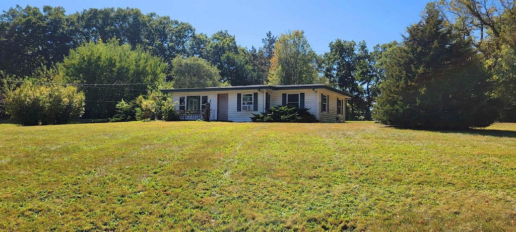 ranch-style home with a front lawn