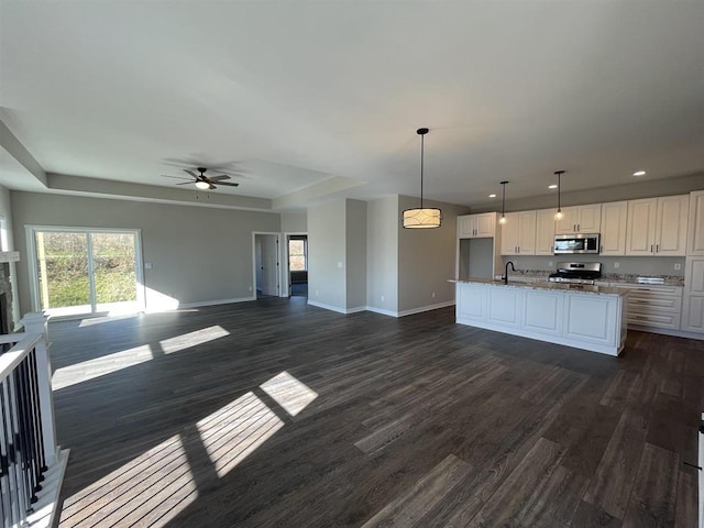 kitchen featuring a sink, stainless steel appliances, and open floor plan