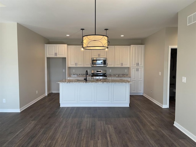 kitchen featuring dark wood-style flooring, baseboards, appliances with stainless steel finishes, and recessed lighting