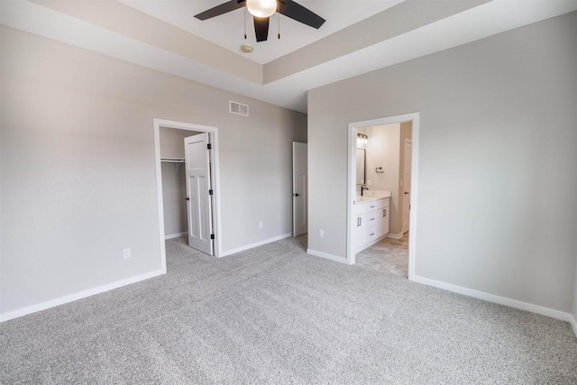 167 E Ash Ln, Milton, WI 53563 - unfurnished bedroom with light colored carpet, a walk in closet, a closet, and ensuite bathroom