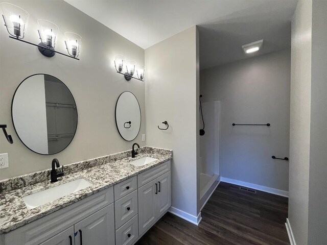 167 E Ash Ln, Milton, WI 53563 - full bath featuring wood finished floors, double vanity, and a shower