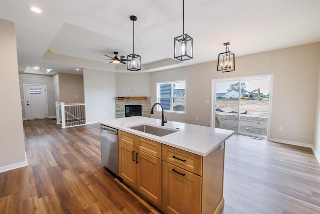 889 Red Hawk Dr, Milton, WI 53563 - kitchen featuring stainless steel dishwasher, a ceiling fan, a raised ceiling, open floor plan, and dark wood-style flooring