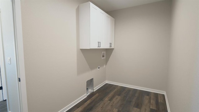 laundry area featuring electric dryer hookup, dark wood finished floors, cabinet space, baseboards, and hookup for a washing machine