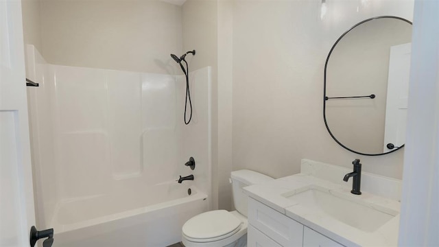 bathroom with toilet, vanity, and  shower combination