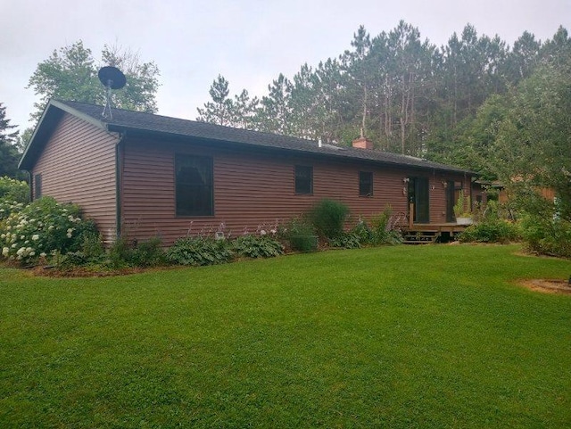 view of side of property with a lawn