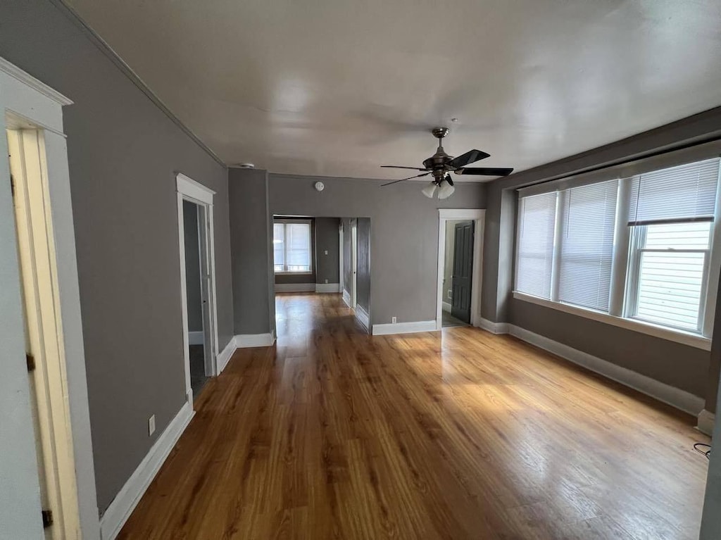 empty room featuring ceiling fan and hardwood / wood-style flooring