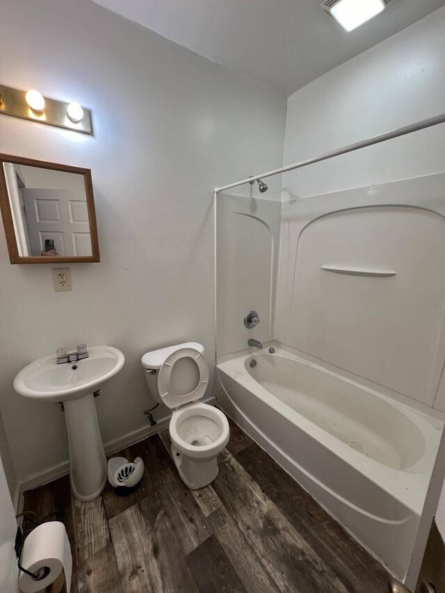 bathroom featuring shower / tub combination, toilet, and wood-type flooring