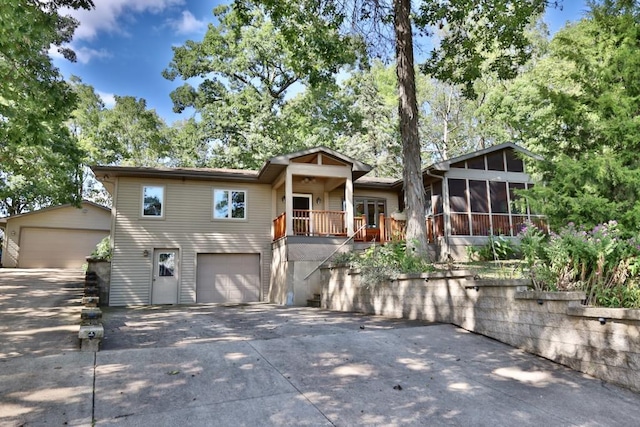 view of front facade featuring a garage and a sunroom