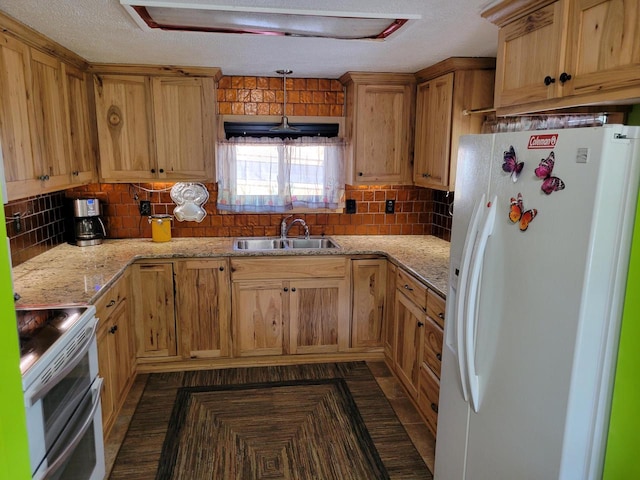 kitchen featuring white refrigerator with ice dispenser, sink, tasteful backsplash, and stainless steel electric range