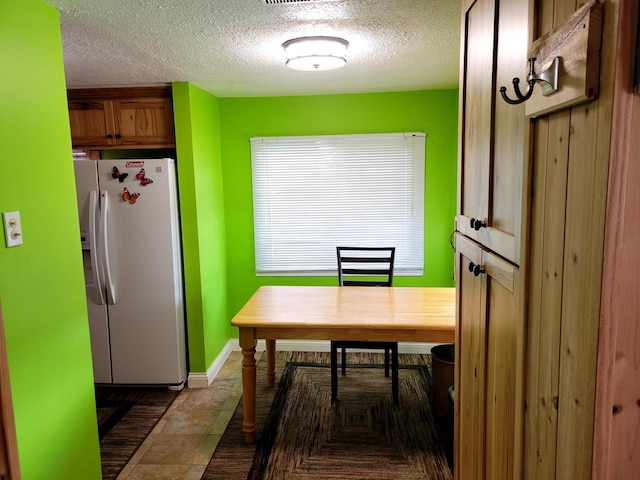 dining area with a textured ceiling