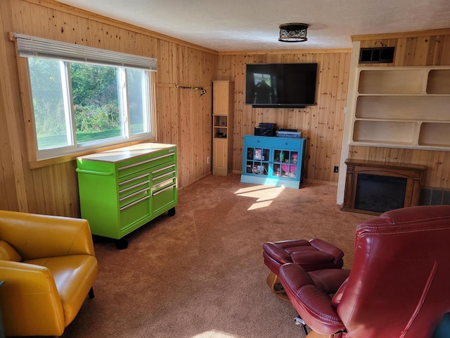 living room with wooden walls, crown molding, and carpet